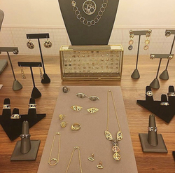 A display of a ollection of jewelry from a single jewelry designer
